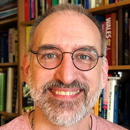 Headshot of a balding, beardy chap with glasses.